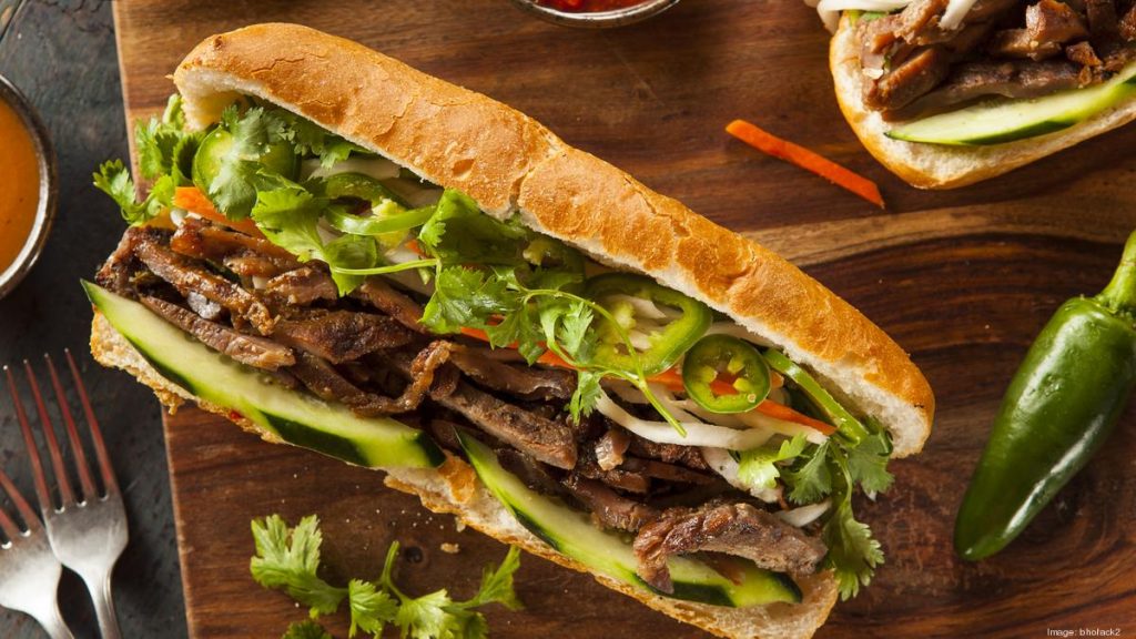 Close up aerial shot of a seemingly beef sub with lush assortment of vegetables.