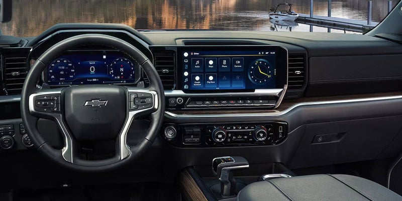 Image showcasing the entire dash of the brand new 2024 Chevrolet Silverado 1500. You can see the huge infotainment center and tech savvy features throughout the front of the truck.